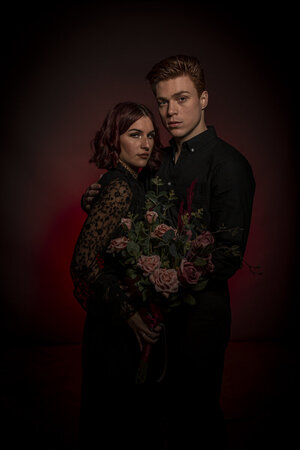 Professional romantic couple photography with flower backdrop