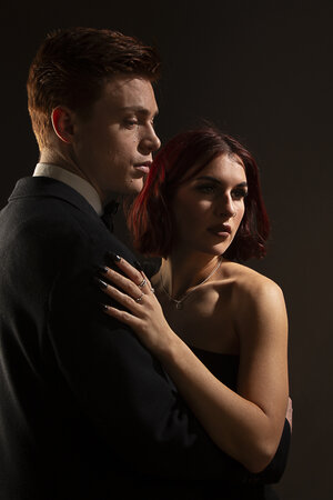 Professional romantic couple portrait in studio with sunset lighting